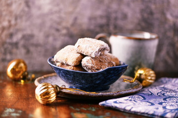Traditional christmas cookies in a bowl on a rustic wooden background. Soft focus.	