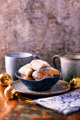 Traditional christmas cookies in a bowl on a rustic wooden background. Soft focus.	
