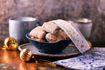 Traditional christmas cookies in a bowl on a rustic wooden background. Soft focus.	