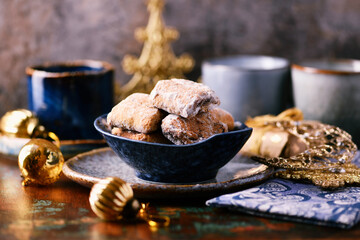 Traditional christmas cookies in a bowl on a rustic wooden background. Soft focus.	