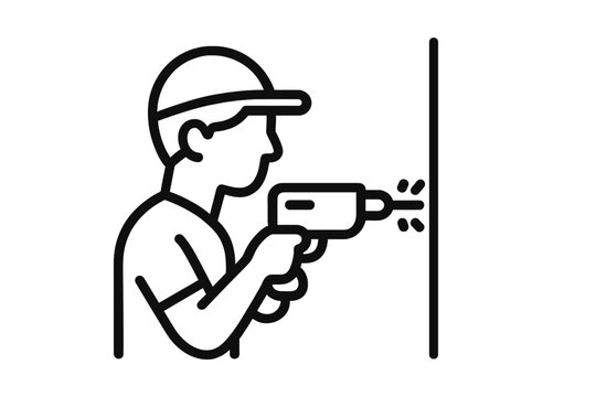 Construction worker drilling a hole in a wall during home renovation