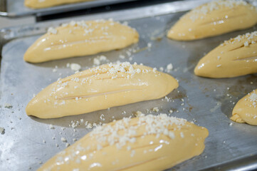 Raw bread loaves preparing for baking in bakery