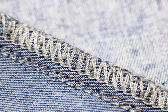 A seam finished with an overlock on denim.