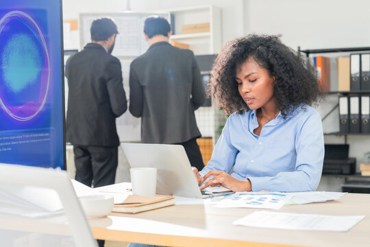Diverse business professionals, both male and female, collaborate in a bright modern office, using an AI powered virtual assistant to brainstorm innovative ideas, analyze big data insights	