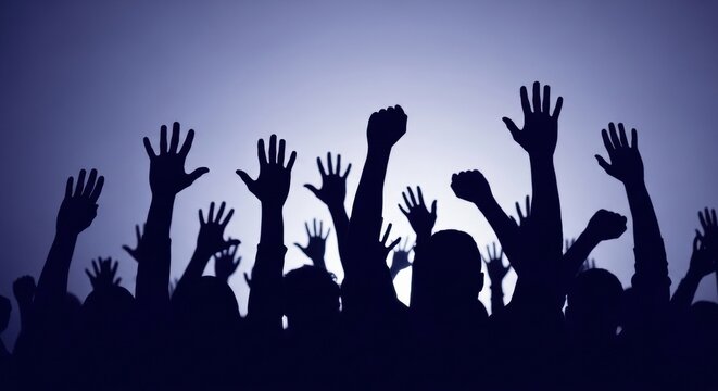 Silhouetted crowd of people with hands raised in the air at a concert or protest, showing unity and participation against a cool blue gradient background with copy space