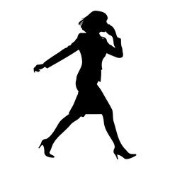 Silhouette of a businesswoman walking and talking on a mobile phone
