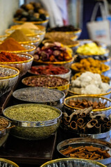 Vibrant display of colorful Arabic spices arranged in traditional bowls at a bustling market