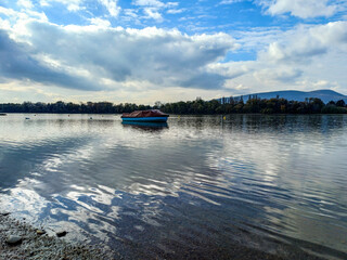 Lonely Boat On Reflective Water