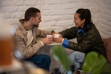 Couple enjoying coffee together at cafe