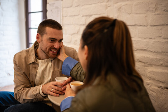 Happy couple enjoying coffee date at cafe