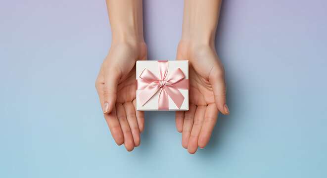 Hands holding white gift box with pink ribbon present 4