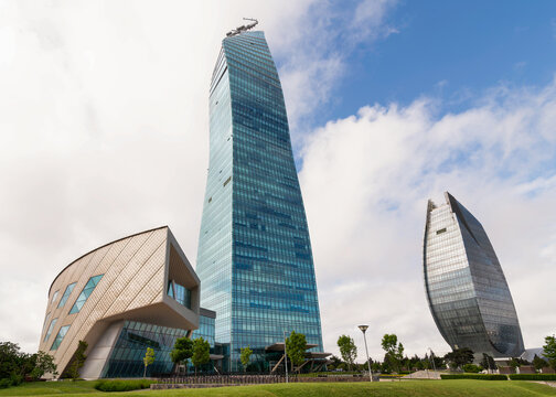 Baku, Azerbaijan - May 7, 2025: The striking SOCAR Tower and the uniquely shaped Azersu Tower rise prominently, showcasing modern architecture against a cloudy sky