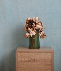 Dried flower arrangement in green vase