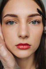 Fototapeta premium closeup of woman with styled eyebrows, young lady having her eyebrows carefully shaped professionally