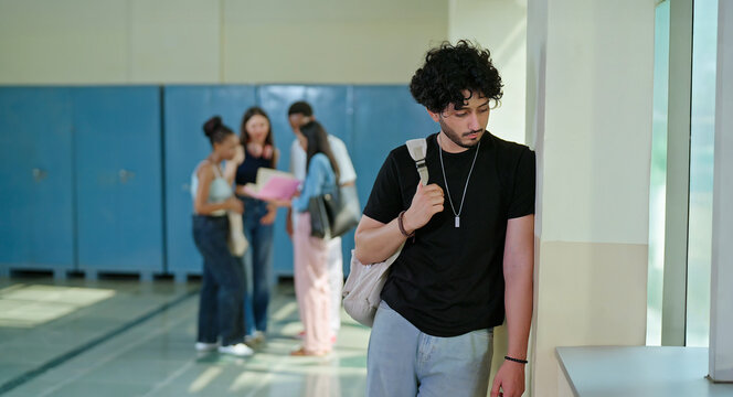 Indian sad young adult gen z man guy wear bag feel low look upset fail in study exam result indoor campus place alone lost tensed male boy suffer mental health issue social bully live bad hostel life