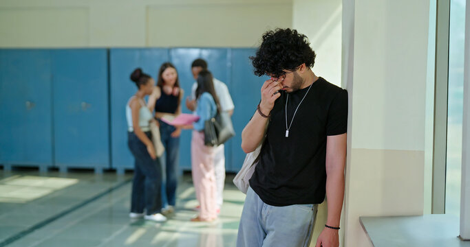 Indian sad young adult gen z man guy wear bag feel low look upset fail in study exam result indoor campus place alone lost tensed male boy suffer mental health issue social bully live bad hostel life