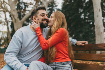 joyful park couple laughing on bench, teacher and designer sharing playful conversation and easy chemistry