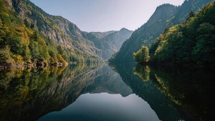 A tranquil mountain lake surrounded by forested cliffs, with tall peaks reflected perfectly in the glassy water. Concept Alpine lake reflections, Forested cliff backdrop, Glassy tranquil water