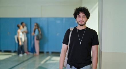 Indian happy young adult gen z proud man male look staring camera standing campus area. Cool pupil...