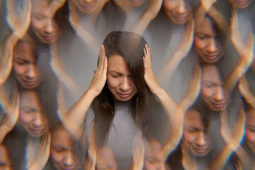 Stressed woman suffering from headache holding her head with hands 