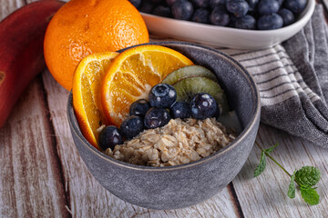 Oats porridge with blueberry, kiwi and orange