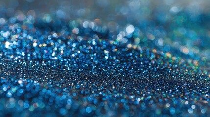 Close-up of blue glitter paper texture with sparkling facets and cool tones