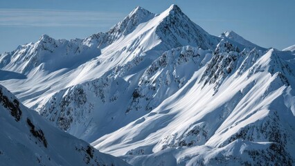 Snow-covered alpine peaks and jagged ridges bathed in sunlight under a clear blue sky. Concept Snow-covered alpine peaks, Jagged ridges bathed in sunlight, Clear blue sky, Sunlit mountain scenery