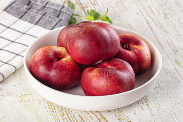Ripe sweet juicy flat nectarines heap