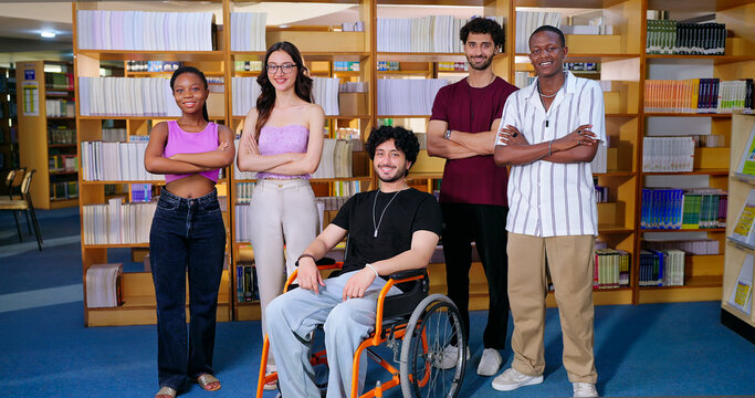 Indian young adult gen z man woman group team proud fold hand look camera indoor place teen girl pupil boy sitting in wheel chair class mate do casual pose cross arms staring cam enjoy new day time
