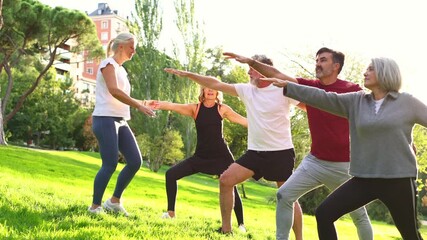 Yoga instructor teaching seniors outdoor class - Powered by Adobe