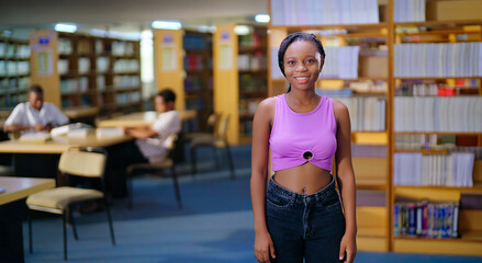 African young adult gen z beautiful lady confident student standing proud look camera indoor library happy smiling girl staring cam do casual pose enjoy joyful day time inside college