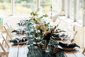 Elegant festive table setting with green decor and glassware
