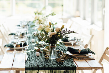 Elegant festive table setting with green decor and glassware