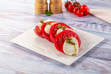 Italian Caprese salad with tomato, mozarella and pesto