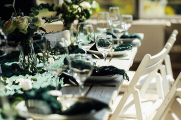 Elegant festive table setting with green decor and glassware