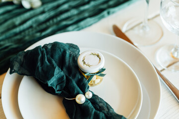 Elegant festive table setting with green decor and glassware