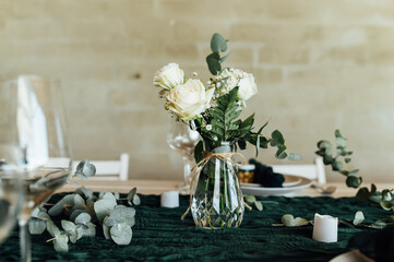 Elegant festive table setting with green decor and glassware