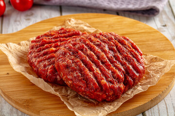 Raw uncoocked red beef round cutlet