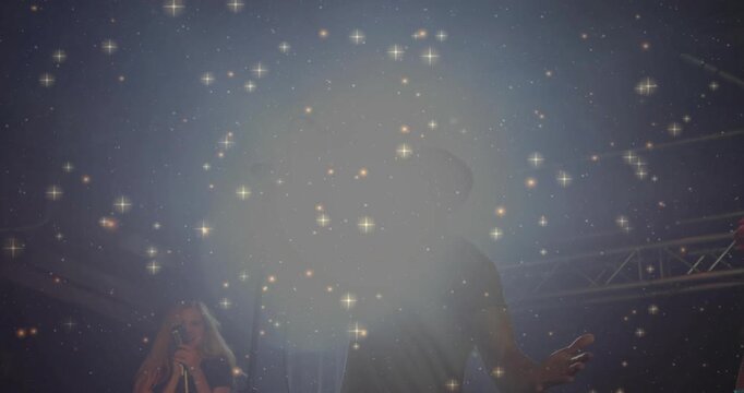 Man lead singer singing on music stage lighting sparking star sparkle overlay shading band for fans