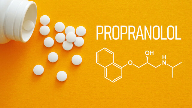 Propranolol Tablets and Chemical Formula on the Orange Background. Beta Blocker White Pills