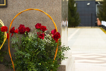 Red Flowers in Baskets Against a Gray Granite Background