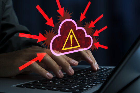Cyber attacks on cloud servers. DDoS attack and cloud service disruption. Hacker using laptop computer.