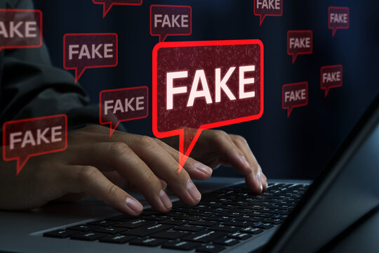 Fake news and misinformation on social media. Malicious disinformation and Clickbait content. Man using laptop computer to spread false information.