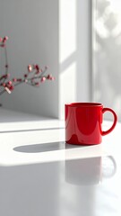 Red Mug on White Table with Sunlight and Shadows.