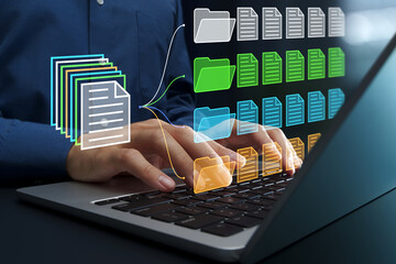 Document classification. Document management system DMS. File and folder icons. Businessperson using laptop computer for managing documents.