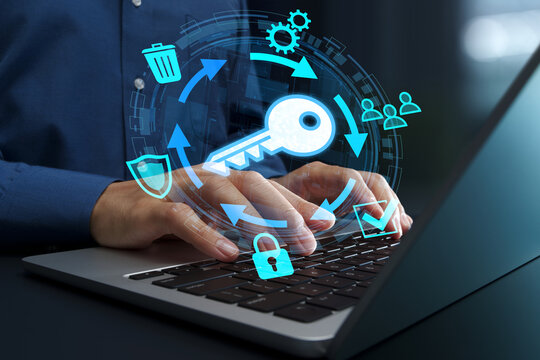 Encryption key management system and lifecycle. Secure key exchange and generation. Businessperson using laptop computer for cryptographic operations.