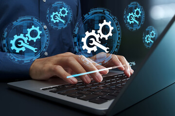 System maintenance solutions. Automated security patch application and updates. Businessperson using laptop computer for scheduled IT system maintenance.