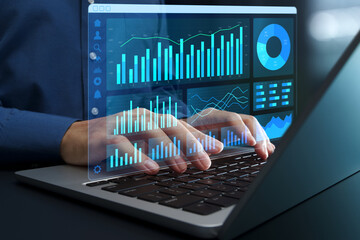 Web analytics dashboard. Marketing data visualization. Statistical graphs and reports. Businessperson analyzing website traffic using a laptop computer.
