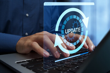 Update of system and software. Security patch and firmware version upgrade. Businessperson using laptop computer to apply bug fixes.