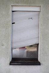 broken shutter on an abandoned ruin
